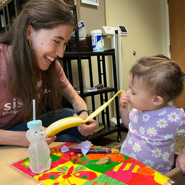 Childing working with SLP in Feeding Therapy - peeling a banana