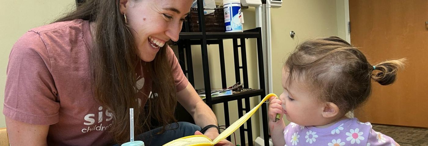 Childing working with SLP in Feeding Therapy - peeling a banana